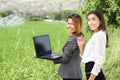 Business women with a laptop in a field with agriculture irrigation system Royalty Free Stock Photo