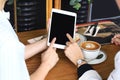 Business women looking at the tablet computer, Colleagues discussing business at cafe, Everywhere is a working place concept. Royalty Free Stock Photo