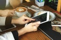 Business women looking at the tablet computer, Colleagues discussing business at cafe, Everywhere is a working place concept Royalty Free Stock Photo