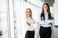 Business women in office hall over panoramic windows. Royalty Free Stock Photo