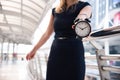 Business women show alarm clock and shocked with late in rush hours when going to work in city urban background. Deadline and wake Royalty Free Stock Photo