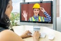 Business woman sit at desk looking at computer screen, have conference video call with factory chief female engineer,