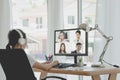 Back view of female employee speak talk on video call online briefing, woman worker have Webcam group conference with coworkers on Royalty Free Stock Photo