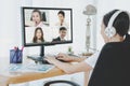 Back view of female employee speak talk on video call online briefing, woman worker have Webcam group conference with coworkers on Royalty Free Stock Photo