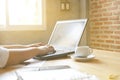 Business women using laptop for analytic financial graph trend forecasting planning at coffee cafe sunlight from window Royalty Free Stock Photo