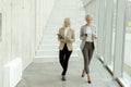 Business women walking in the office corridor Royalty Free Stock Photo