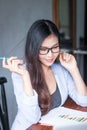 Business women wear glasses Beautiful asians Have fun in the office inside the house Royalty Free Stock Photo