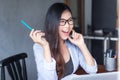 Business women wear glasses Beautiful asians Have fun in the office inside the house during work Royalty Free Stock Photo