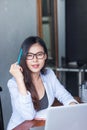 Business women wear glasses Beautiful asians Have fun in the office inside the house Royalty Free Stock Photo