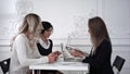 Business women working at meeting ,one of busines woman showing on a diagram