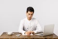 Business, work and interview concept. Busy serious handsome, young asian man sitting desk in office drink coffee Royalty Free Stock Photo