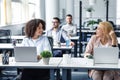 Business workers take care of health and social distancing. Smiling european and african american woman at workplace Royalty Free Stock Photo