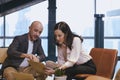 Business workers are using laptop computer. Coworkers discussing in meeting room at the office Royalty Free Stock Photo