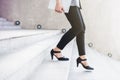 Business working woman steps walking at outdoor stair, side view