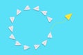 Business. A yellow paper airplane will fly out of the circle of white airplanes. Blue background. Flat lay. The concept