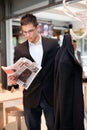 Business young man concerted reading the newspaper Royalty Free Stock Photo