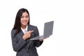 Business young woman holding laptop standing on isolated white background. Portrait of beautiful young girl pointing at Royalty Free Stock Photo