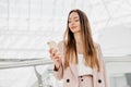 Business young woman in a suit uses her mobile phone and looks at the screen Royalty Free Stock Photo