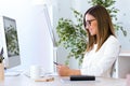 Business young woman using her mobile phone in the office. Royalty Free Stock Photo