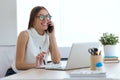 Business young woman using her mobile phone in the office. Royalty Free Stock Photo