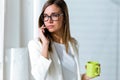 Business young woman using her mobile phone in the office. Royalty Free Stock Photo