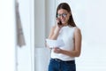 Business young woman using her mobile phone in the office. Royalty Free Stock Photo