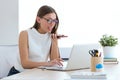 Business young woman working with her mobile phone and laptop in the office. Royalty Free Stock Photo