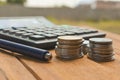 ballpen and coins or calculate on table