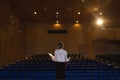 Businessawoman practicing and learning script while standing in the auditorium Royalty Free Stock Photo