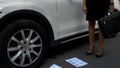 Businesslady gets out of car, drops phone and documents, hateful work and pms