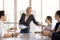 Businesslady share handout sheets materials to diverse young colleagues Royalty Free Stock Photo