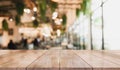 Businessman on abstract blur light effect backgroundEmpty wooden table top with lights bokeh on blur restaurant background