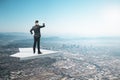 Businessman on abstract paper plane looking into the distance on creative bright sky background with mock up place. Future, Royalty Free Stock Photo