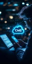 Businessman Accessing Cloud-Based CMS on Mobile Device, Glowing Text in Icon on Laptop Screen Royalty Free Stock Photo