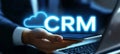 Businessman Accessing Cloud Based CRM System via Mobile Device, CRM Text in Glowing Cloud