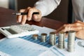 Businessman accountant Calculating on data documents And pile Stack Of coins, the savings money investment. financial Budget