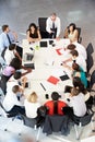 Businessman Addressing Meeting Around Boardroom Table Royalty Free Stock Photo