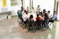 Businessman Addressing Meeting Around Boardroom Table Royalty Free Stock Photo