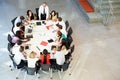 Businessman Addressing Meeting Around Boardroom Table Royalty Free Stock Photo