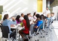 Businessman Addressing Meeting Around Boardroom Table Royalty Free Stock Photo