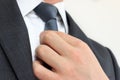 Businessman adjusting his necktie Royalty Free Stock Photo