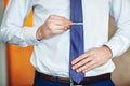 Businessman adjusting his necktie, ready for business