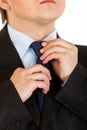 Businessman adjusting his tie. Close-up. Royalty Free Stock Photo