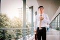 Businessman adjusting necktie before working time