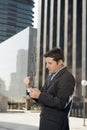 Businessman adjusting shirt cuff link outdoors exterior office building