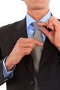 Businessman adjusting tie