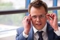 Businessman adjusts his glasses Royalty Free Stock Photo