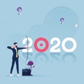 Businessman aiming arrow to target-2020 business goals concept