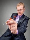 Businessman aiming by red dart