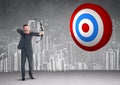 Businessman aiming at the target board against hand drawn cityscape in background Royalty Free Stock Photo